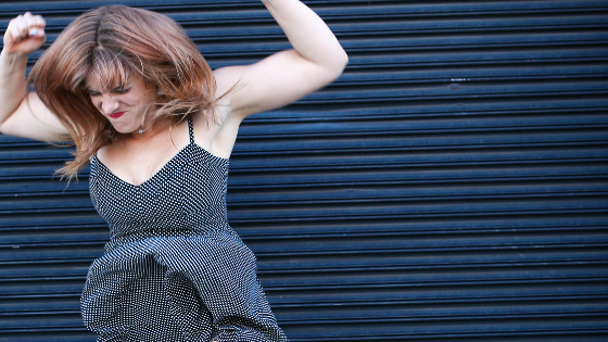 Jenna J is wearing a black and white polka dot dress and looks like she is throwing a temper tantrum.