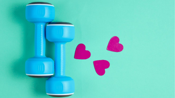 Turquoise background with a set of blue dumbbells and three fuschia hearts.