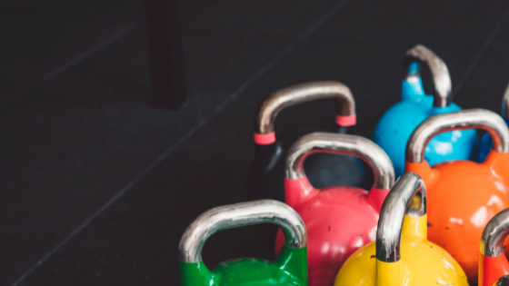 Multi-Colored Kettlebells On A Black Background