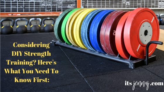 Rainbow colored barbell plates on a rack in a gym. The floor is black and there are chalkboards and kettlebells in the background. The words: "Considering DIY Strength Training? Here's What You Need To  Know First" in yellow text.